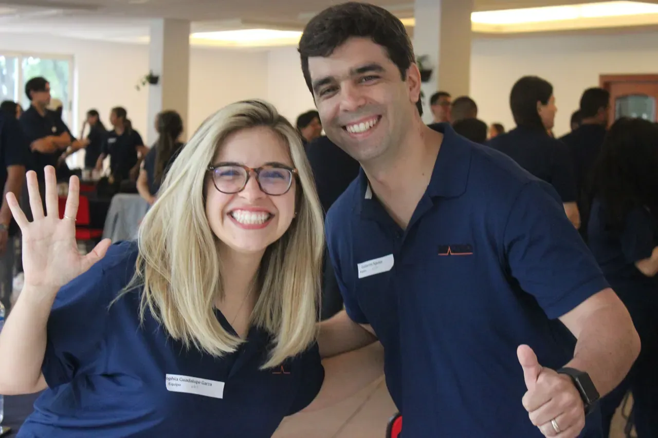 Dos colaboradores sonrientes posando después de una actividad de integración, destacando el ambiente positivo del equipo